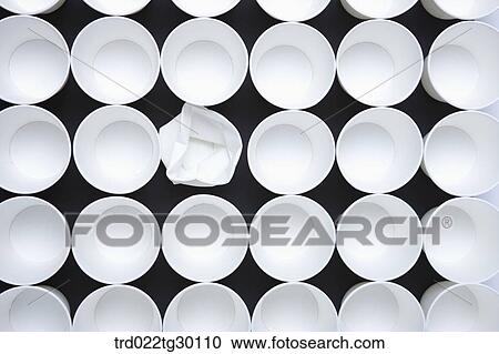 Stock Image - One crumpled paper cup with other neat paper cups. Fotosearch
