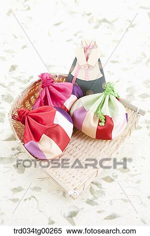 Piece of Korean traditional clothes and lucky bags on strainer View Large Photo Image Stock Photography - Piece of Korean traditional clothes and lucky bags on strainer. Fotosearch