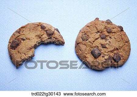 Stock Image - Piled cookies and pieces of cookies on the dish . Fotosearch