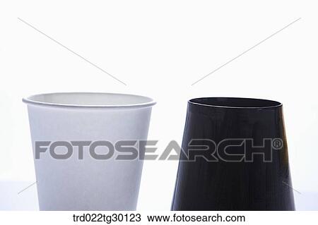 Stock Image - Piled white paper cups with other scattered paper cups. Fotosearch