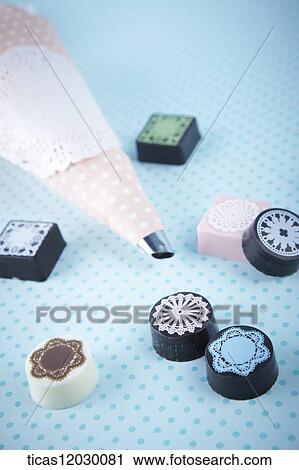 Pink icing bag and lace patterned chocolate View Large Photo Image Stock Image - Pink icing bag and lace patterned chocolate. Fotosearch