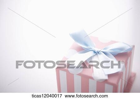 Pink polka dot gift box with blue ribbon View Large Photo Image Stock Photo - Pink polka dot gift box with blue ribbon . Fotosearch