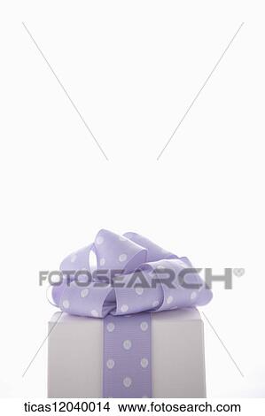 Picture - Purple polka dot ribbon gift box. Fotosearch