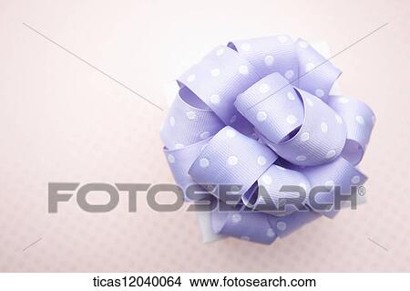 Picture - Purple polka dot ribbon gift box. Fotosearch