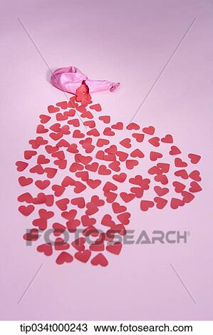 Stock Image - Red heart from the ripped pink balloon. Fotosearch