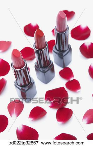 Stock Photo - Red lipstick and rose petal. Fotosearch