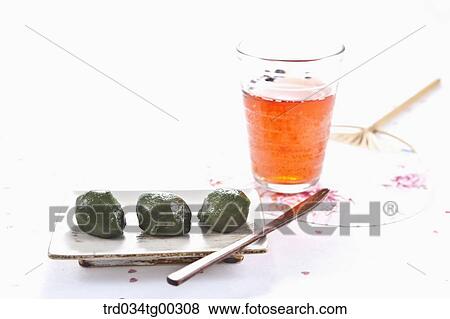 Stock Photo - Rice cake, a glass of drink, and a fan . Fotosearch