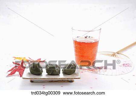 Rice cake, a glass of drink, and a fan View Large Photo Image Stock Photo - Rice cake, a glass of drink, and a fan . Fotosearch