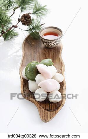 Rice cake and a cup of tea with pine branch View Large Photo Image Stock Photo - Rice cake and a cup of tea with pine branch . Fotosearch