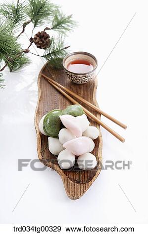 Stock Photo - Rice cake, chopsticks, and a cup of tea with pine branch . Fotosearch