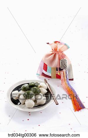 Rice cake, colorful patched lucky bag, and traditional clothes accessory View Large Photo Image Stock Photograph - Rice cake, colorful patched lucky bag, and traditional clothes accessory . Fotosearch