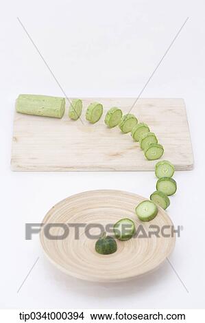 Sliced cucumber pieces to the dish View Large Photo Image Picture - Sliced cucumber pieces to the dish . Fotosearch