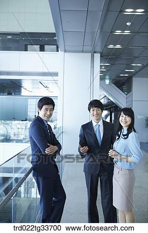Smiling businessmen in the hallway View Large Photo Image Stock Image - Smiling businessmen in the hallway. Fotosearch