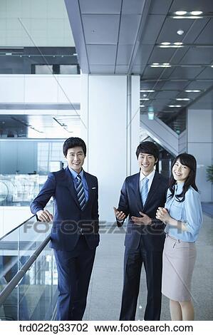 Stock Image - Smiling businessmen in the hallway. Fotosearch
