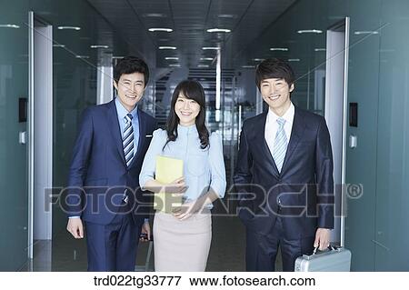 Smiling businessmen in the hallway View Large Photo Image Stock Photo - Smiling businessmen in the hallway. Fotosearch