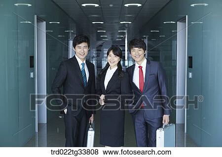 Smiling businessmen in the hallway View Large Photo Image Stock Photo - Smiling businessmen in the hallway. Fotosearch