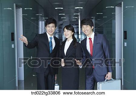 Stock Photograph - Smiling businessmen in the hallway. Fotosearch