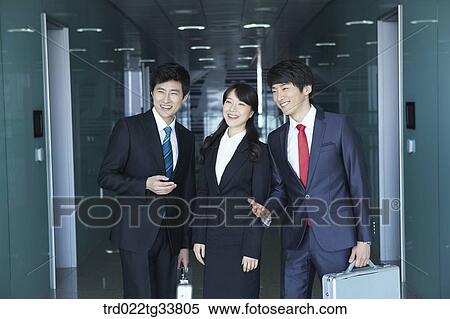 Stock Photography - Smiling businessmen in the hallway. Fotosearch