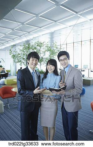 Stock Image - Smiling businessmen in the lounge. Fotosearch