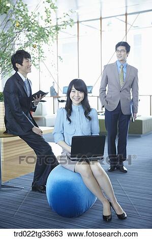 Stock Image - Smiling businessmen in the lounge. Fotosearch