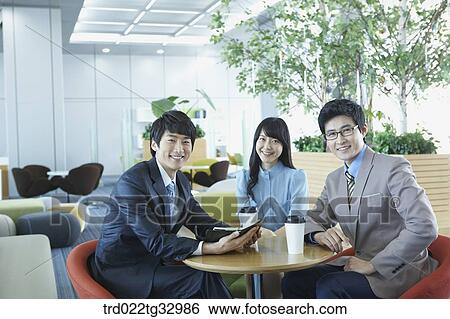 Stock Photograph - Smiling businessmen in the lounge. Fotosearch