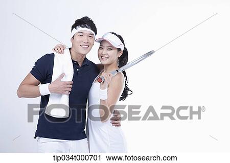Stock Image - Smiling male and female tennis players. Fotosearch