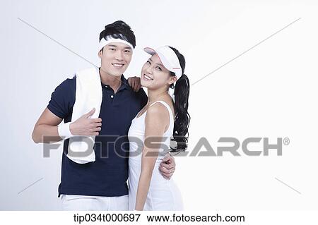 Stock Photo - Smiling male and female tennis players. Fotosearch