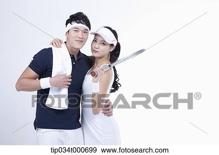 Stock Photo - Smiling male and female tennis players. Fotosearch