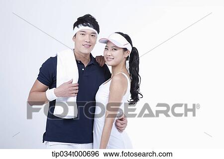 Stock Photograph - Smiling male and female tennis players. Fotosearch