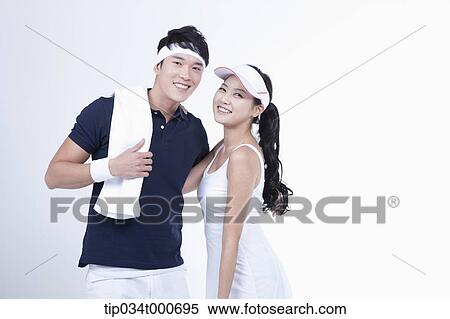 Stock Photography - Smiling male and female tennis players. Fotosearch