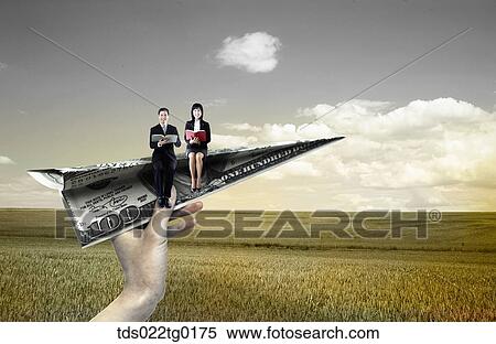 someone's hand holding paper airplane which has business people View Large Photo Image Stock Photography - someone's hand holding paper airplane which has business people. Fotosearch