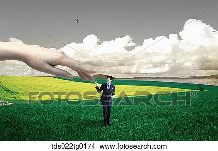 someone's hand touches businessman who is standing on the field View Large Photo Image Picture - someone's hand touches businessman who is standing on the field. Fotosearch