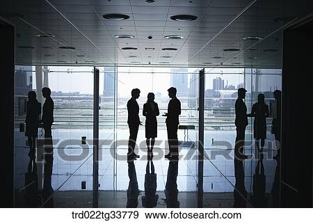 Talking businessmen in the hallway View Large Photo Image Stock Photo - Talking businessmen in the hallway. Fotosearch