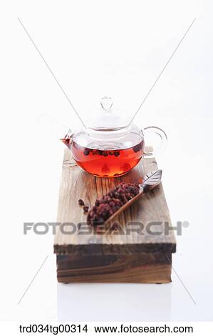 Picture - Tea setting and dried fruit on the wooden dish. Fotosearch