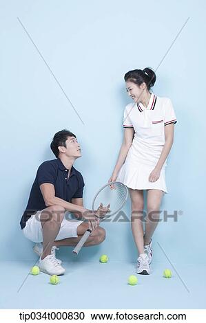 Stock Image - Tennis players with a racket and balls. Fotosearch