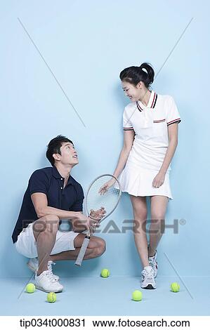 Stock Image - Tennis players with a racket and balls. Fotosearch