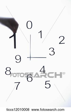 Stock Photo - The clock and the hand holding number one . Fotosearch