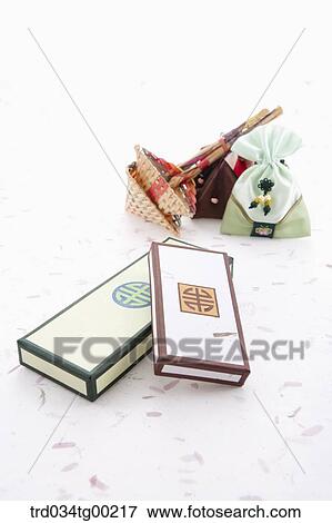 Stock Photo - Traditional boxes with strainers and lucky bags around. Fotosearch