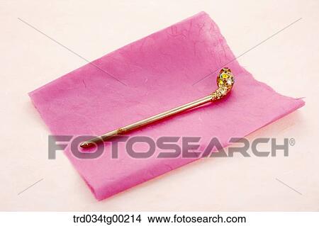 Picture - Traditional gold hair accessory on the pink Korean paper . Fotosearch