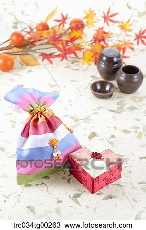 Traditonal lucky bag and box with jars and colored leaves behind View Large Photo Image Stock Image - Traditonal lucky bag and box with jars and colored leaves behind. Fotosearch