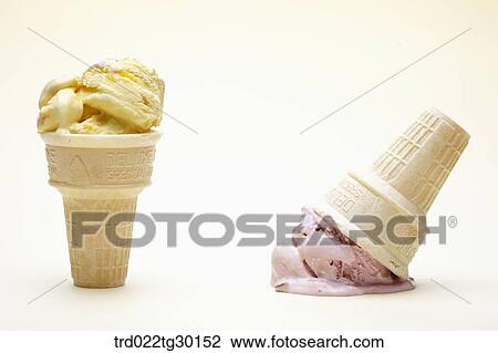 Stock Image - Vanila ice cream con and another crushed strawberry ice cream cone. Fotosearch