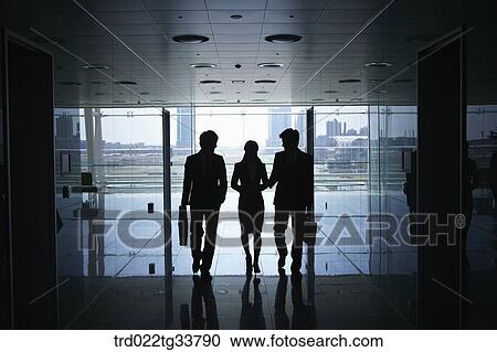 Stock Image - Walking businessmen in the hallway. Fotosearch
