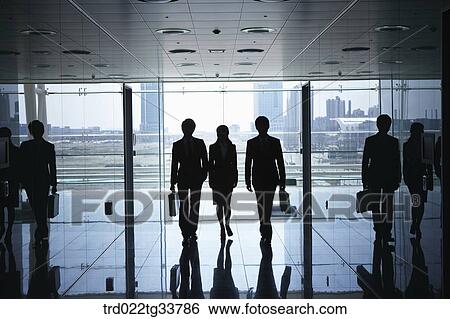 Walking businessmen in the hallway View Large Photo Image Stock Photograph - Walking businessmen in the hallway. Fotosearch