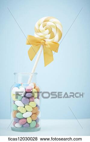 Yellow lollipop in jelly bottle View Large Photo Image Stock Photo - Yellow lollipop in jelly bottle . Fotosearch
