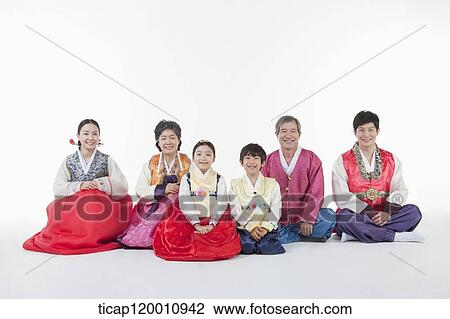 a big family sitting on the floor wearing Hanbok View Large Photo Image Stock Image - a big family sitting on the floor wearing Hanbok. Fotosearch
