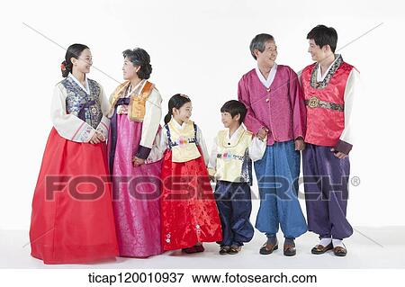 Stock Photo - a big family standing in a line wearing Hanbok. Fotosearch