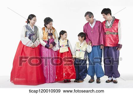 Stock Photo - a big family standing in a line wearing Hanbok. Fotosearch