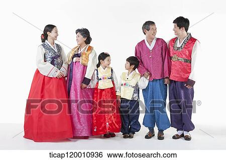 Stock Photograph - a big family standing in a line wearing Hanbok. Fotosearch