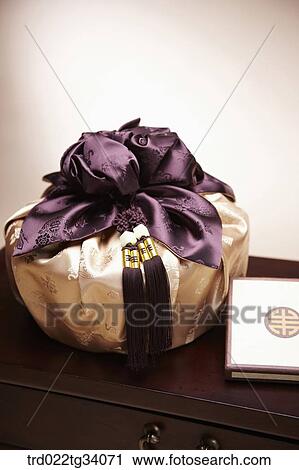 Stock Image - a book and a package in Korean traditional wrap. Fotosearch