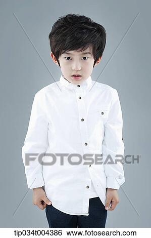 a boy in white shirt standing View Large Photo Image Stock Photograph - a boy in white shirt standing . Fotosearch